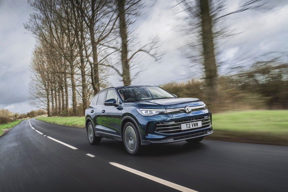 Volkswagen Tiguan driving on a road.