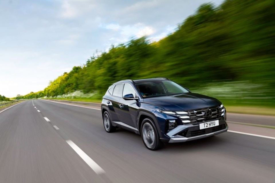 Hyundai Tucson driving on a road.