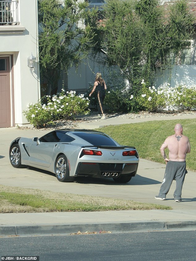 He remained by her sports car