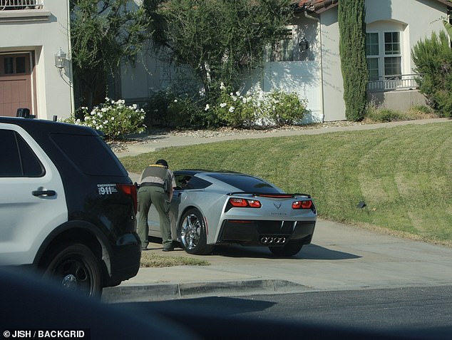 One of the police officers appeared to be speaking with Denise inside her car