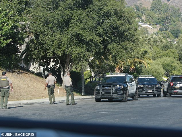 The police presence outside the property