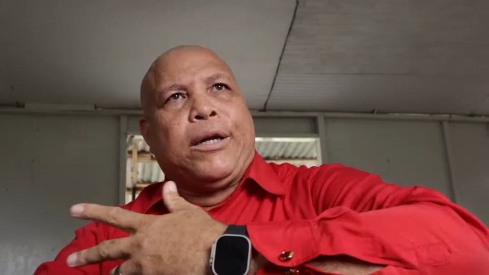 Man in red shirt speaking.