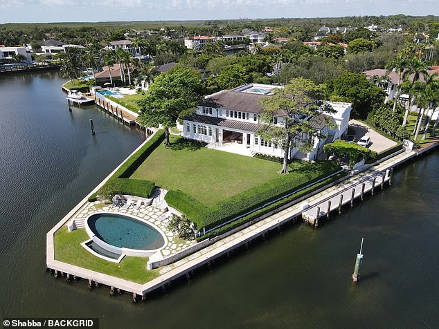 The lavish home boasts seven bedrooms, an 18-car garage, wine cellar and its own dock directly onto the water