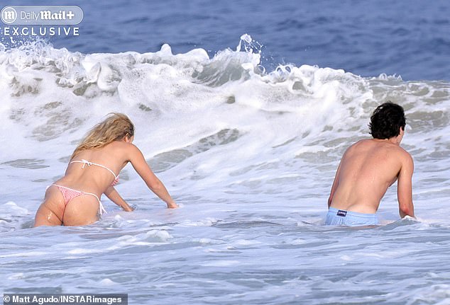 Apple dived into waves with one of her male friends