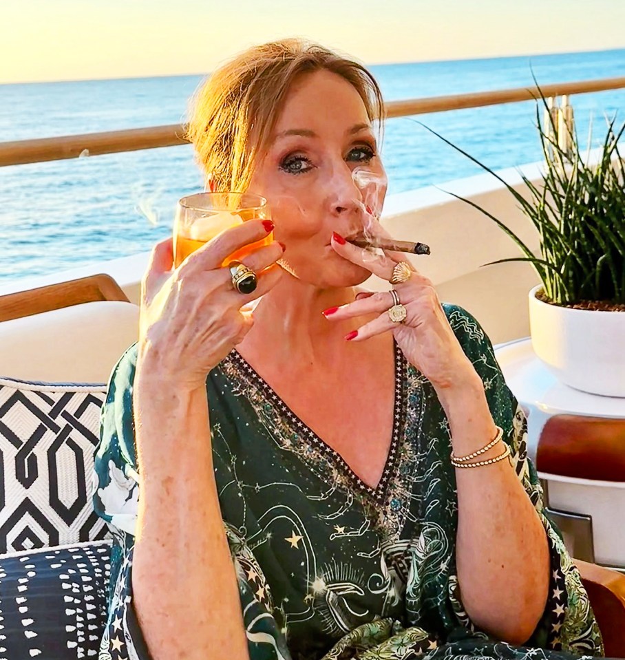J.K. Rowling on a boat, smoking a cigar and drinking.