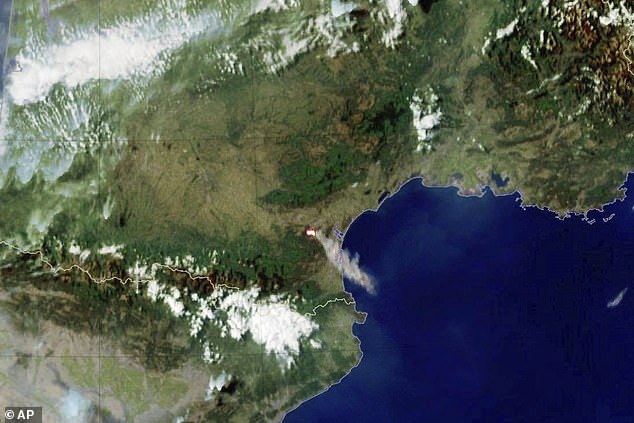This photo provided by Meteo France shows smoke billowing from a wild fire in southern France, Tuesday, August 5