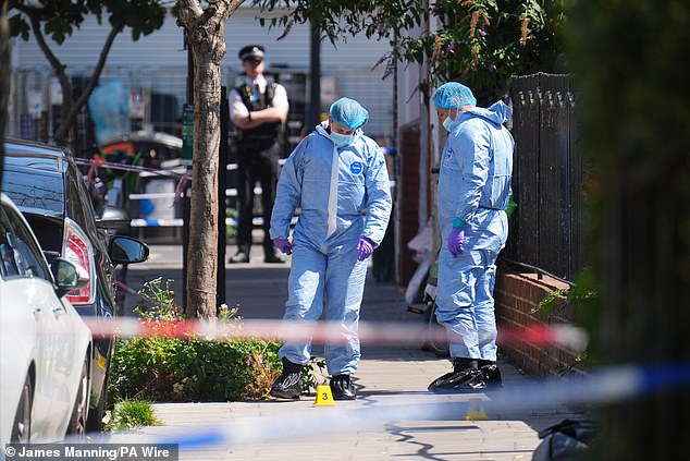 Four forensic officers in scrubs and masks were at the scene yesterday afternoon