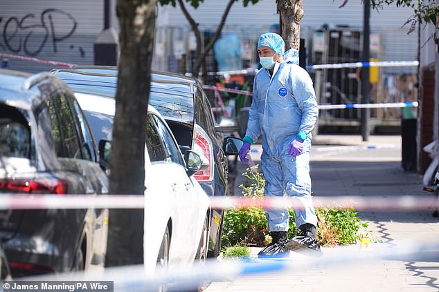 Forensic police officers at the scene on Dynevor Road in Stoke Newington yesterday