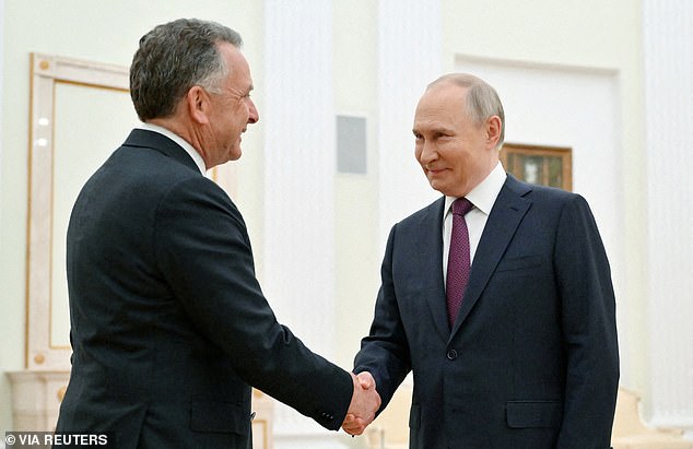The grinning Russian leader could be seen shaking hands with the US president's trusted representative on Wednesday morning