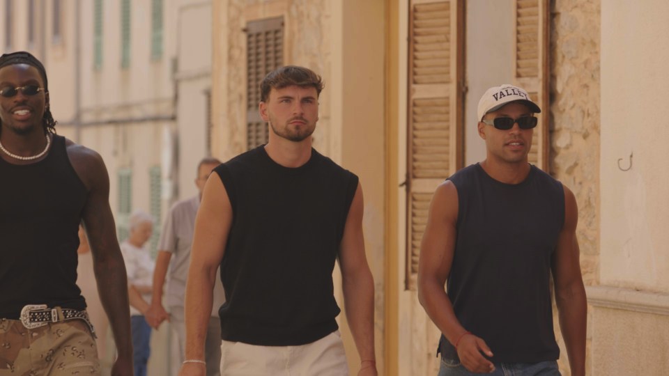 Three men walking down a street.