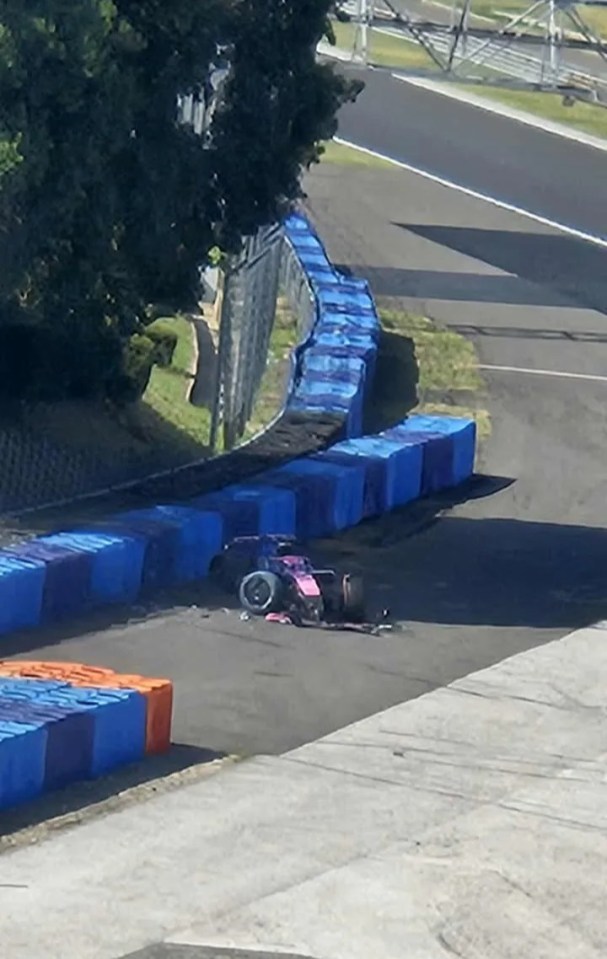 Damaged Formula 1 car on racetrack.