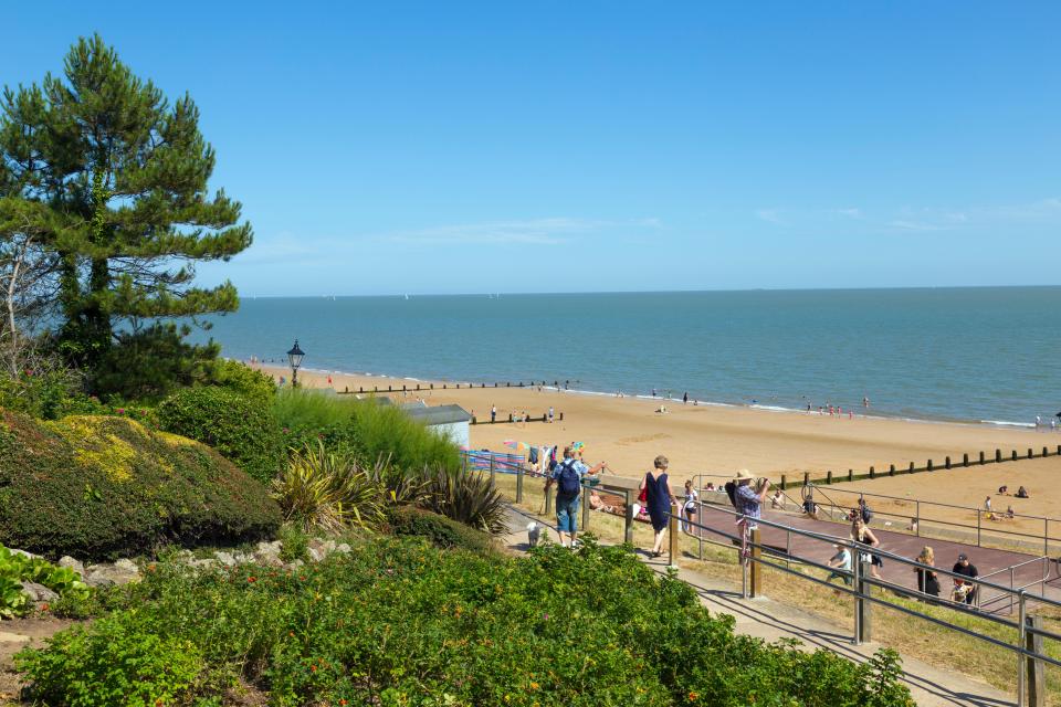 Frinton-on-Sea beach with people walking down to the sand.
