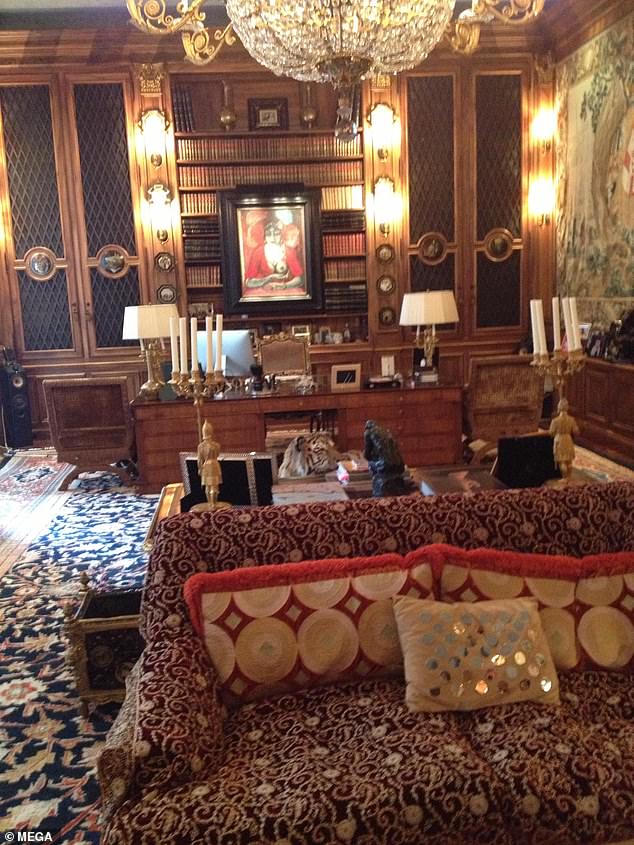 A taxidermied tiger is seen at the centre of the photograph of one of the rooms in Epstein's home