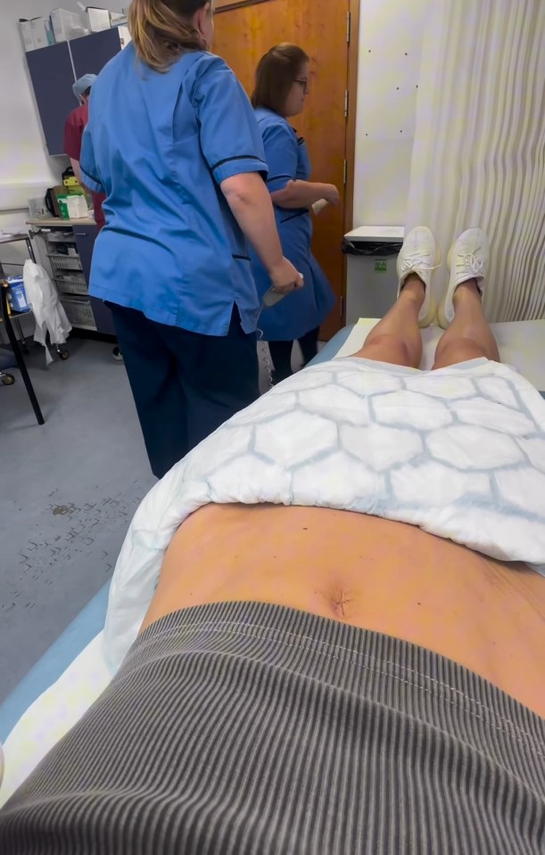 Patient in hospital room with nurses.
