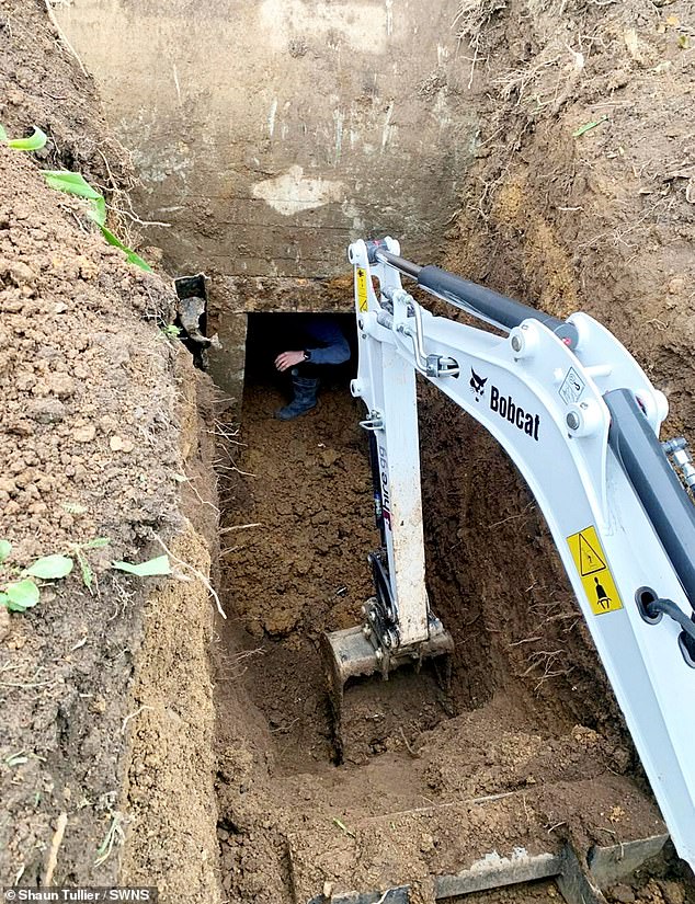 The entrance to the bunker can be seen partially obstructed by tonnes of soil during the excavation