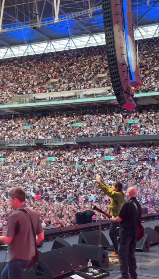 Oasis performing at a sold-out Wembley Stadium.