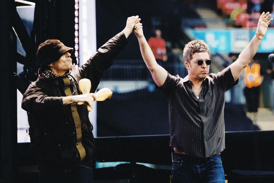 Liam and Noel Gallagher of Oasis on stage at Wembley Stadium.