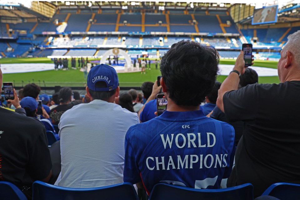 Chelsea FC fans filming a presentation at Stamford Bridge.