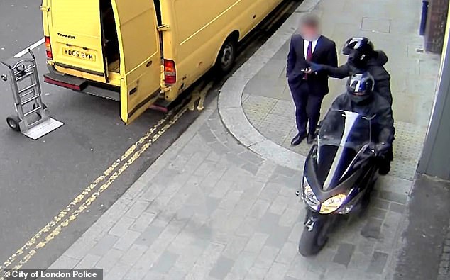 CCTV images show a moped mugger snatching a mobile phone from the hands of a City businessman without stopping