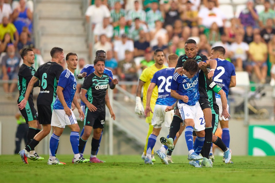 Soccer players contesting the ball during a match.
