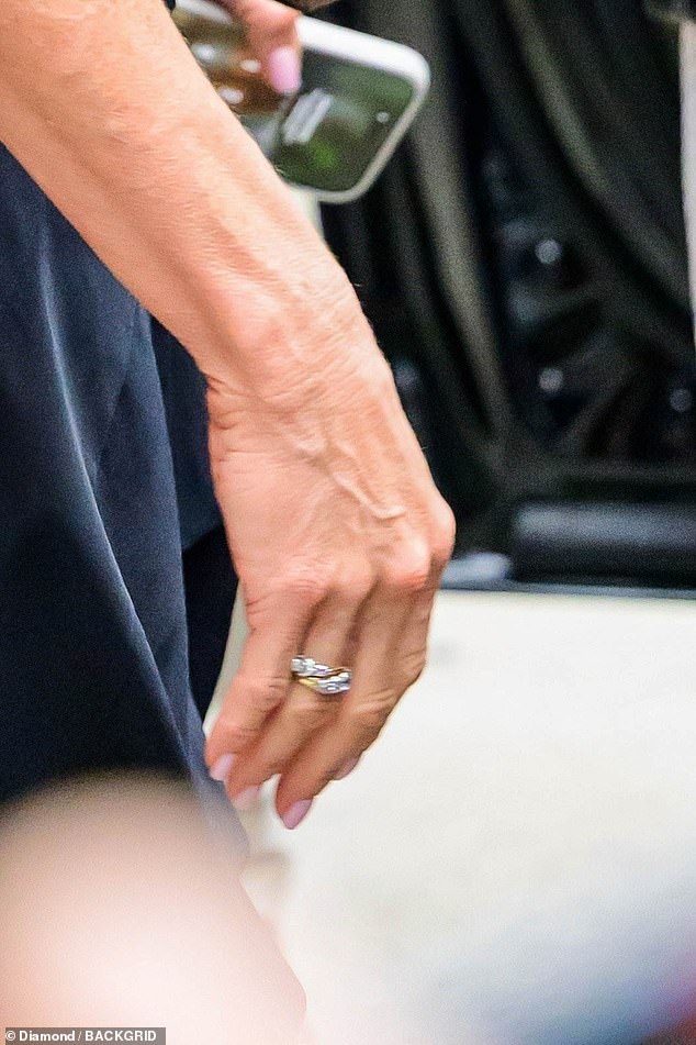 She sported some striking jewelry, including a gold band decorated with sparkling diamonds that she wore on her right ring finger