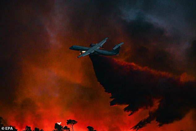 A De Havilland Dash firefighting aircraft drops fire retardant on a forest fire burning in Saint Laurent de la Cabrerisse, Aude department, France, 6 August 2025