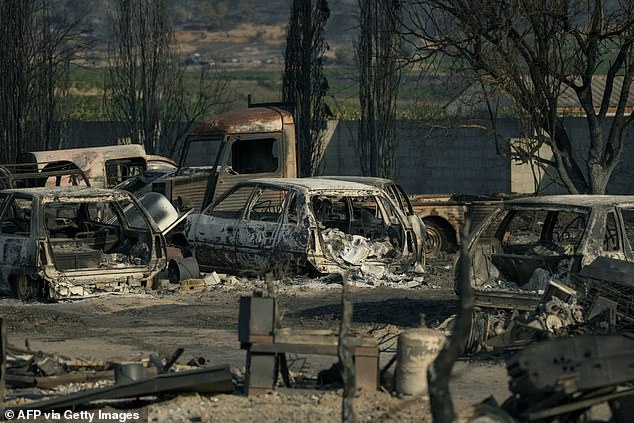 Burnt veichles are seen due to a wildfire that broke out in Saint-Laurent-de-la-Cabrerisse, southwestern France
