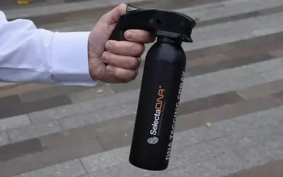 Person holding SelectaDNA tagging spray.