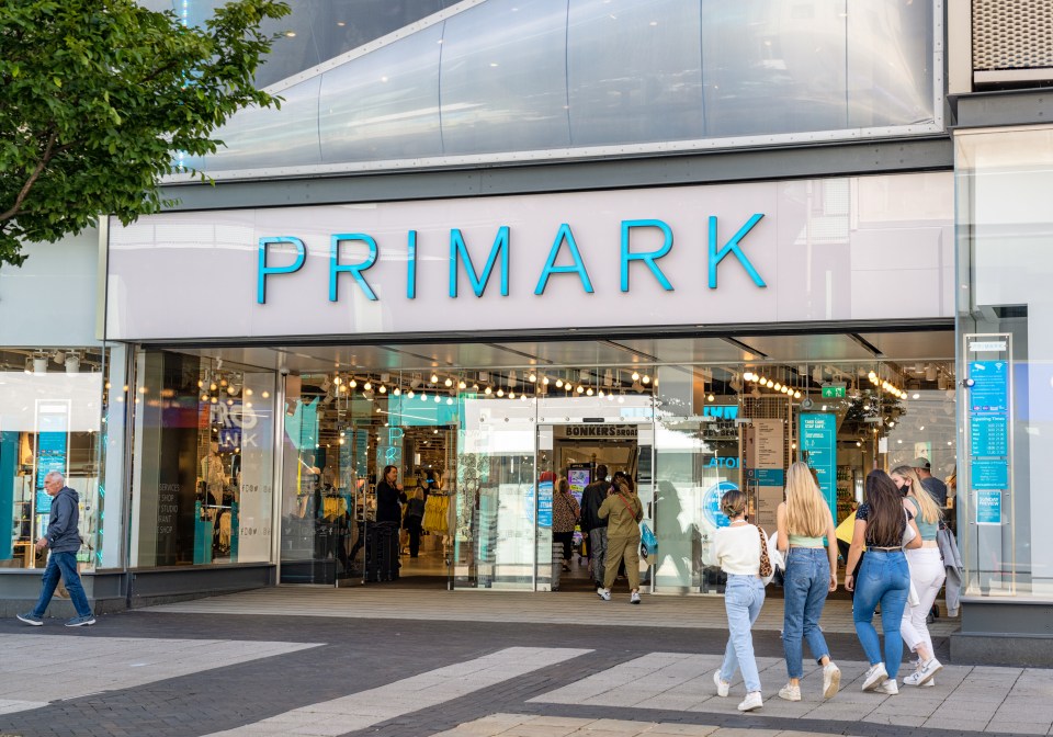 People walking past a Primark store.