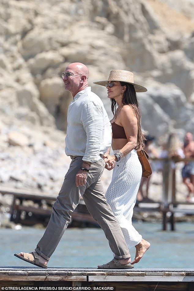 They sweetly held hands as they walked along the pier