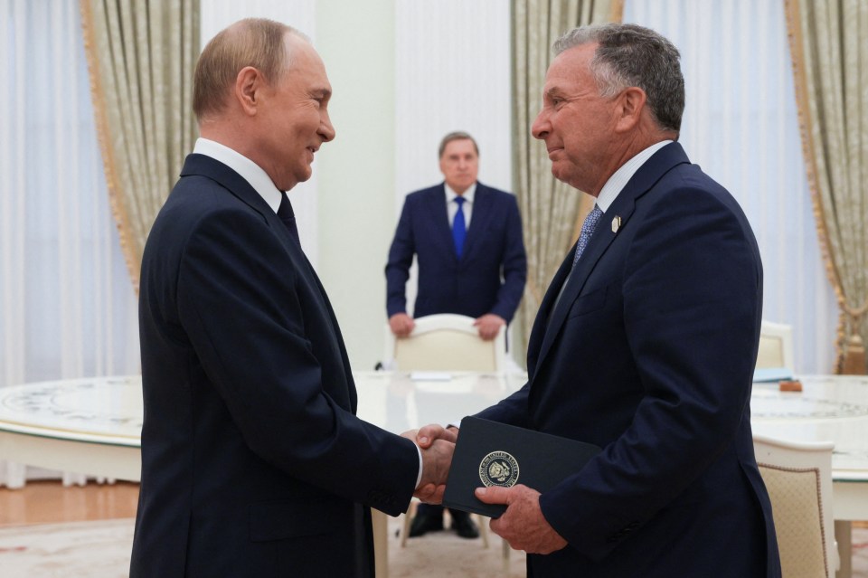 Vladimir Putin shaking hands with Steve Witkoff.