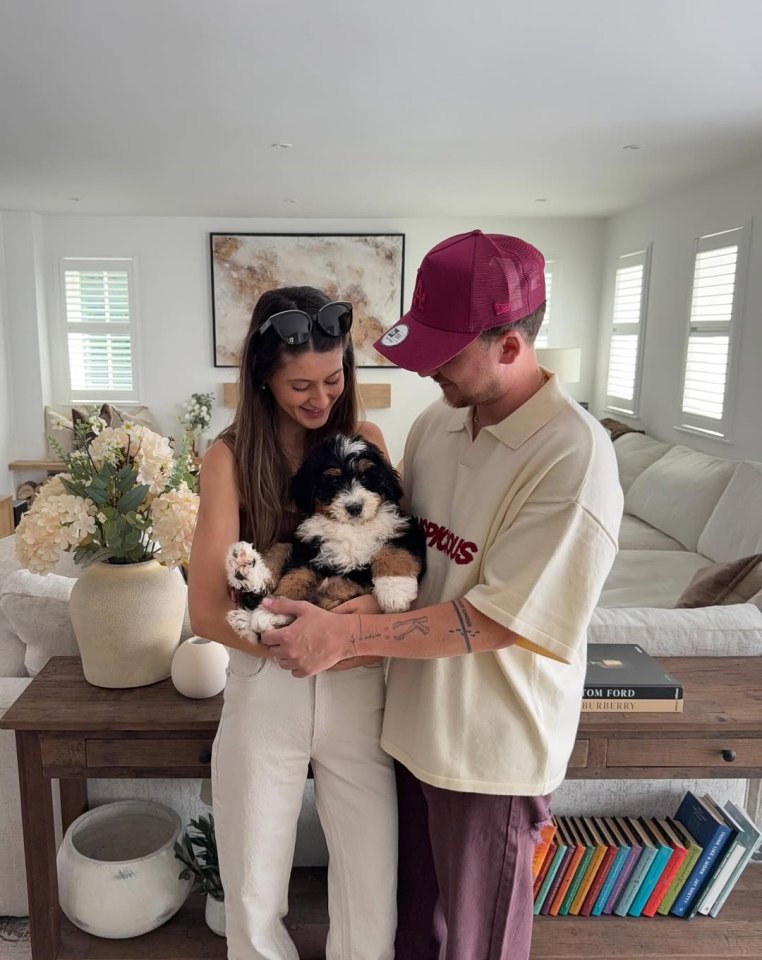 Conor Maynard and Kitty Bertrand holding their puppy.