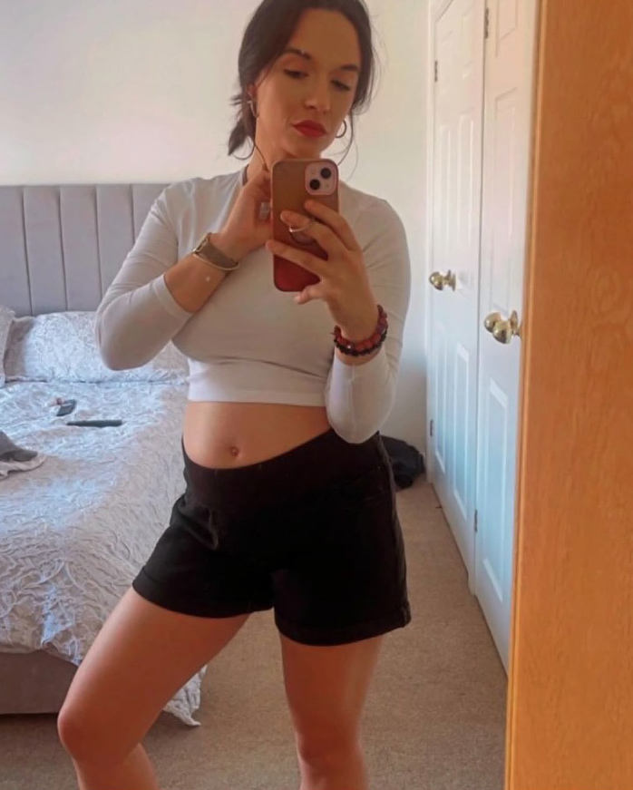 Pregnant woman taking a selfie.