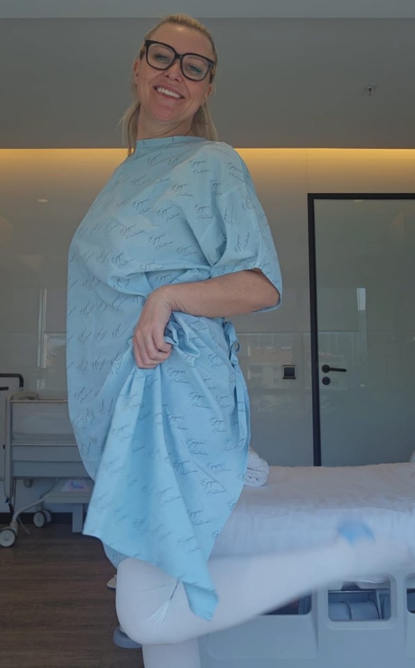 Woman in a hospital gown after a mummy makeover surgery.