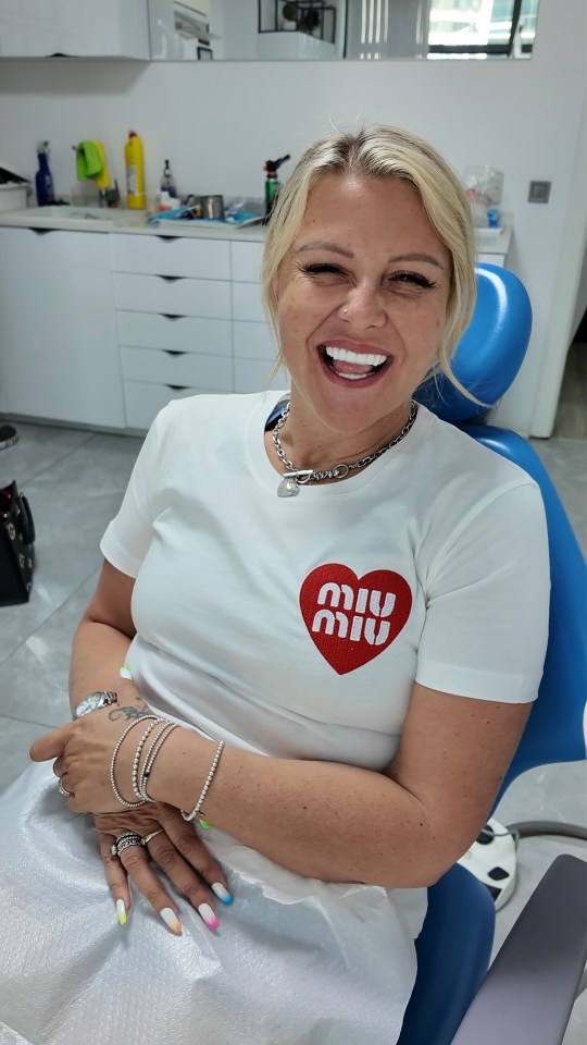 Woman smiling after dental procedure.