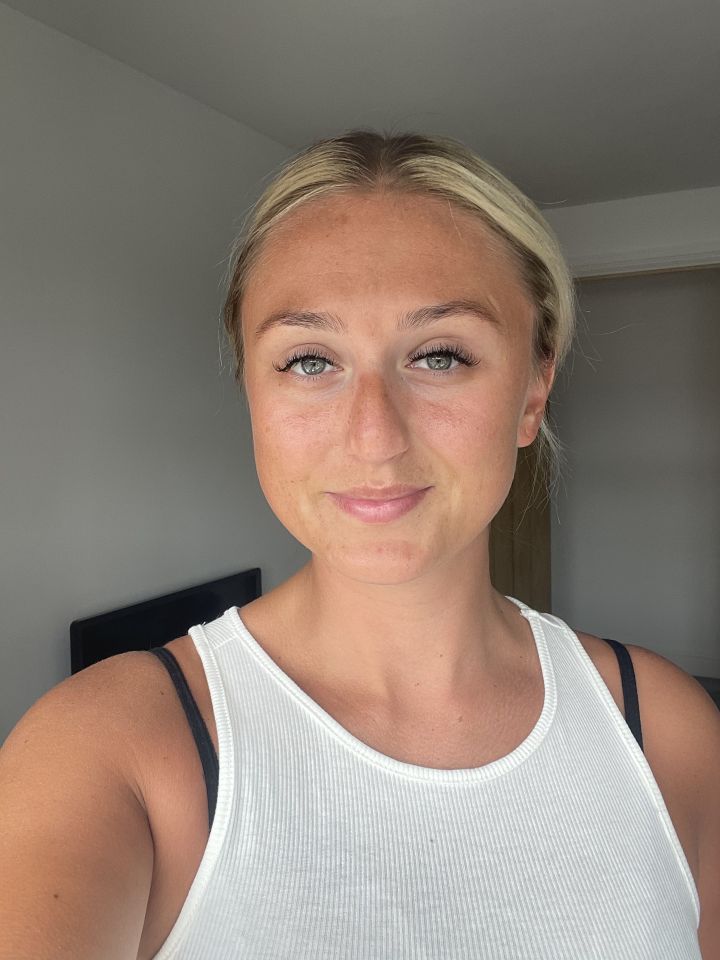 Woman wearing a white tank top.
