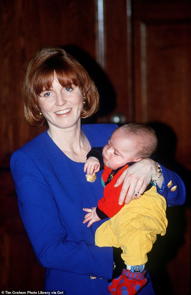 The Duchess of York is pictured cradling a baby at St Thomas's Hospital in London on January 14, 1992
