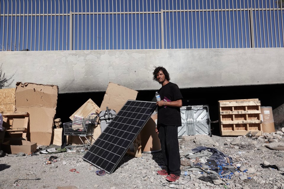 Homeless man in Las Vegas tunnels with solar panel.