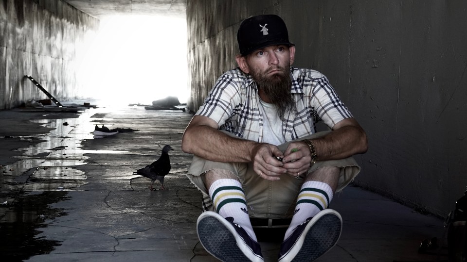 A homeless man sits in a Las Vegas tunnel.