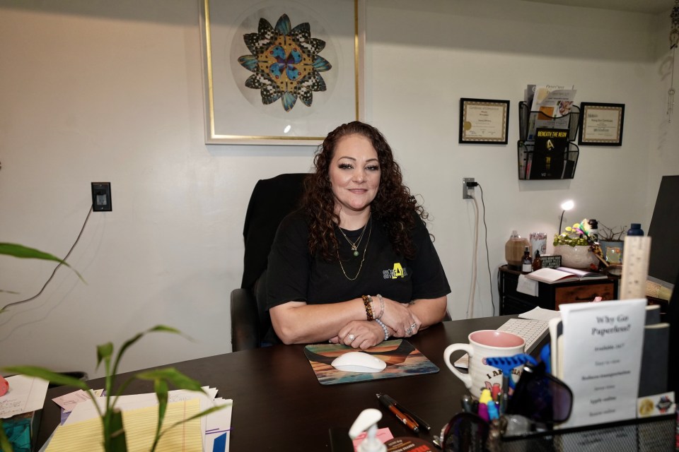 Woman sitting at desk in office.