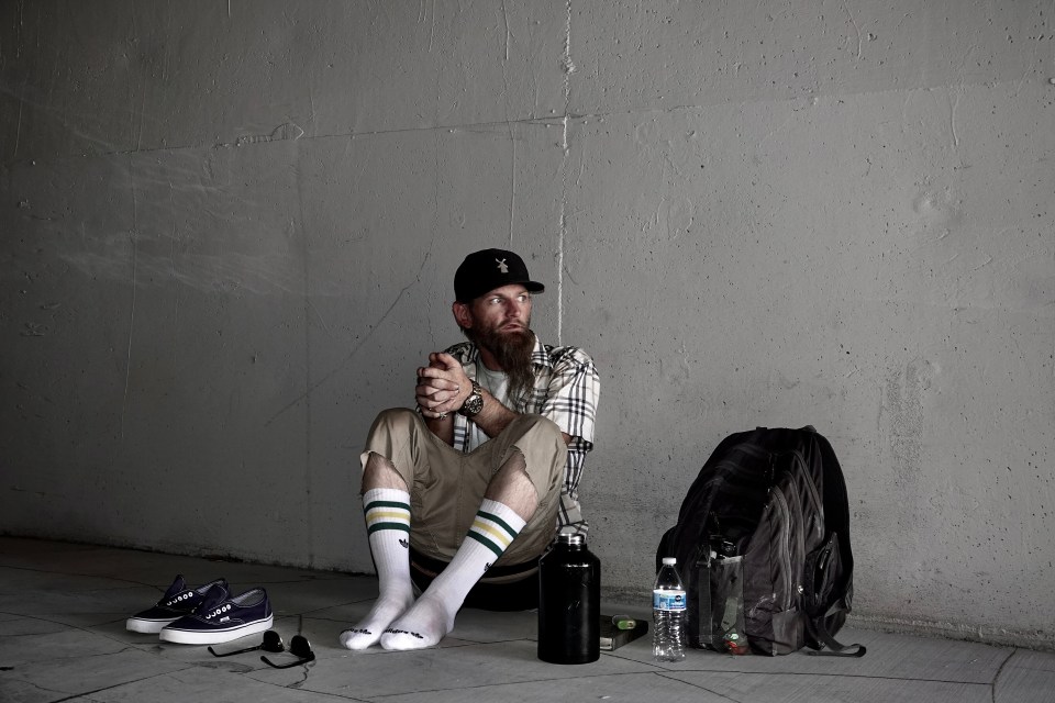 Homeless man sitting in Las Vegas tunnel.