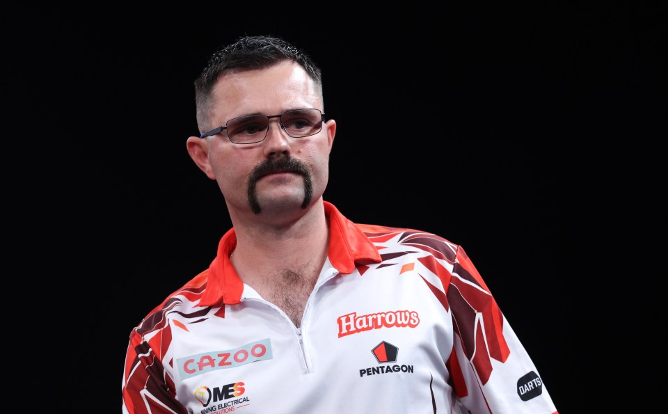 Damon Heta during a darts match.