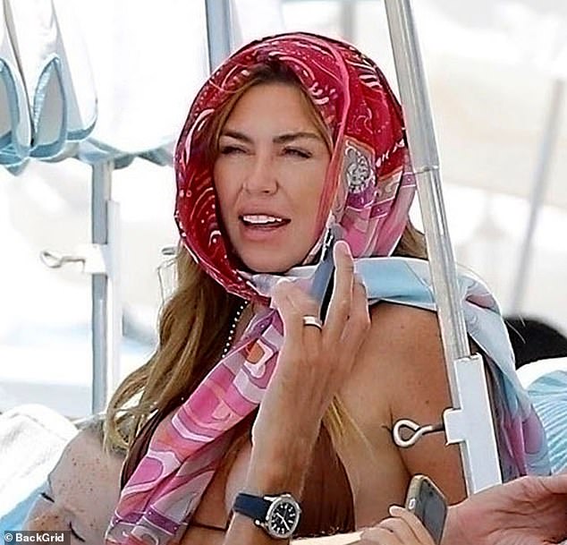 Abbey looked as though she couldn't bare the sweltering heat as she wrapped a scarf around her head to keep out of the sun