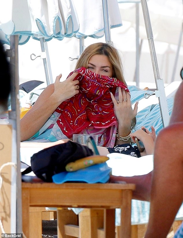 Abbey covered her face with a stylish red pattern scarf