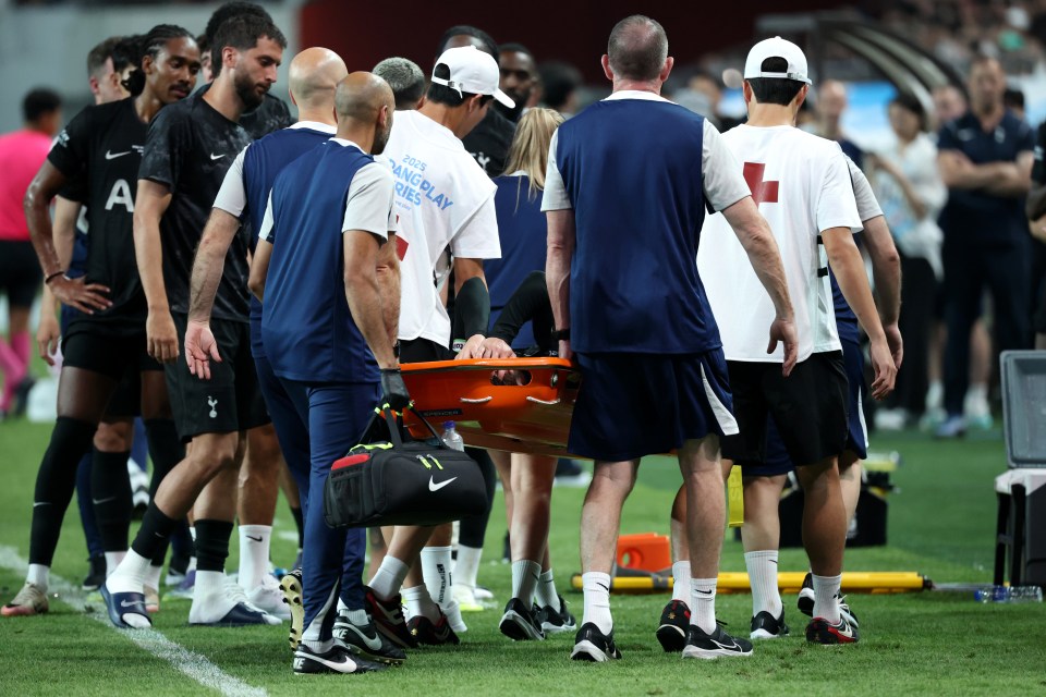 James Maddison of Tottenham Hotspur being stretchered off the field after an injury.