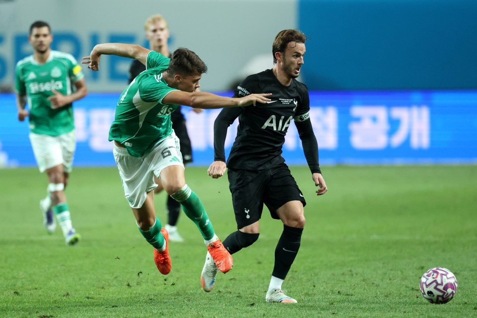 James Maddison of Tottenham Hotspur challenged by a Newcastle United player.