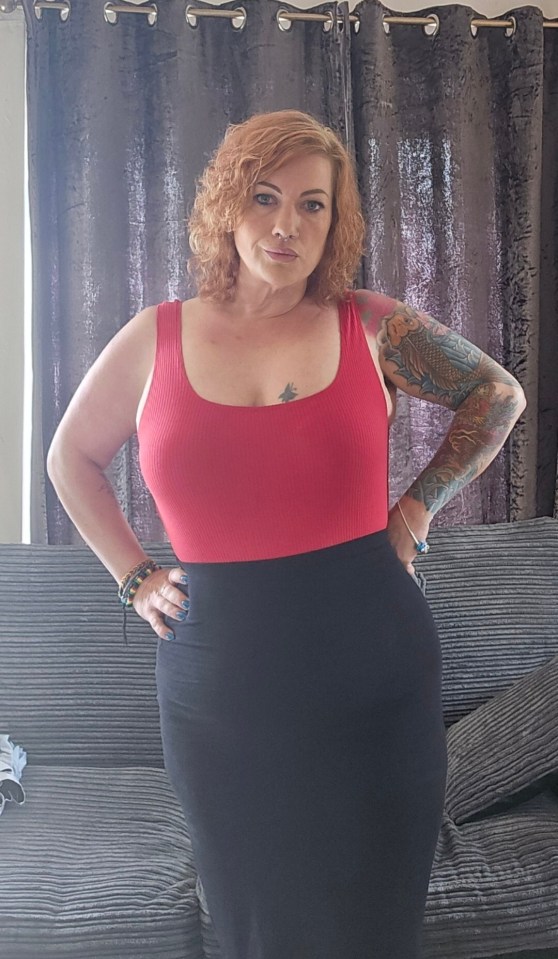 Woman in red top and black skirt.