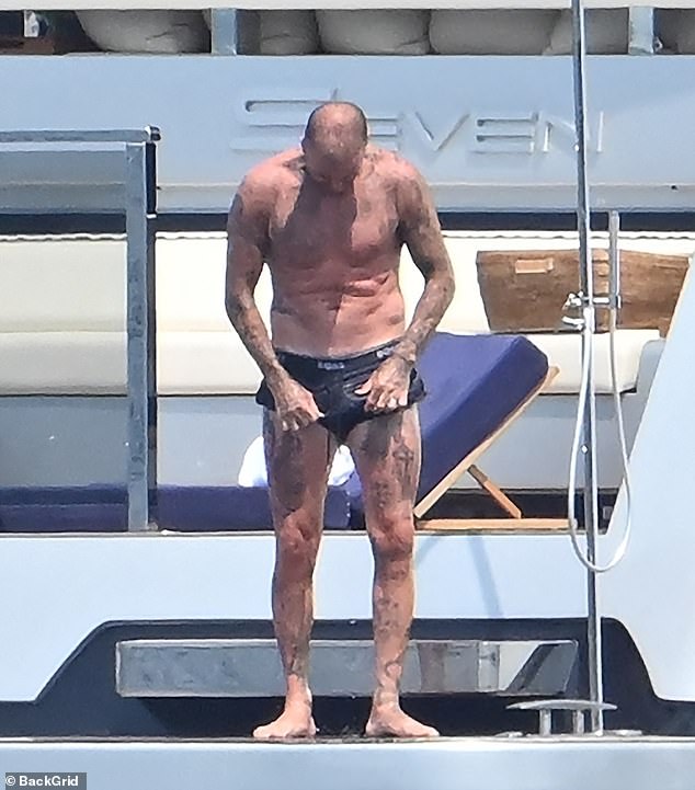 David was seen readjusting his skimpy ensemble after hitting the high seas