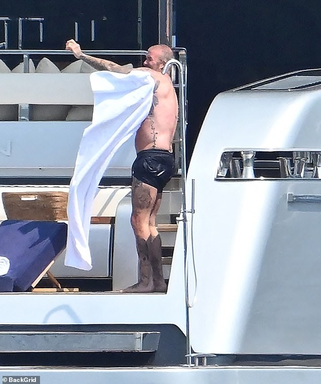 The hunk towelled himself off during the outing on the high seas