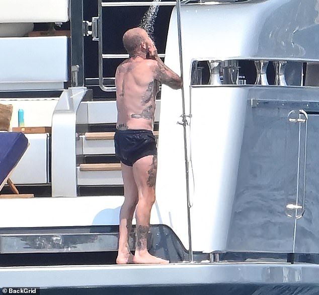 He was cooling off in the shower while showing off her tattooed frame
